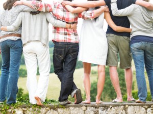 Rear View of Friends Standing on Stone Wall