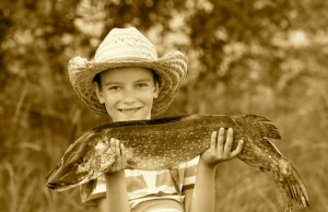 Boy holds big pike he just caught