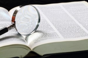 Dictionary and magnifying glass