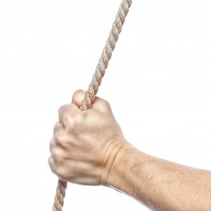 Hand holds a thick rope. On a white background.