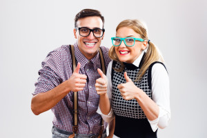 Happy nerdy couple showing thumbs up