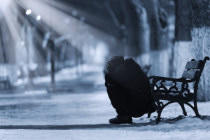 Depressed woman in front of a bench