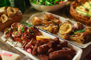 Grilled chicken meat and sausages, pie and salad for dinner