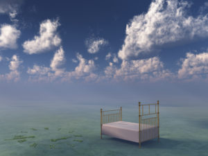 Bed in surreal peaceful landscape